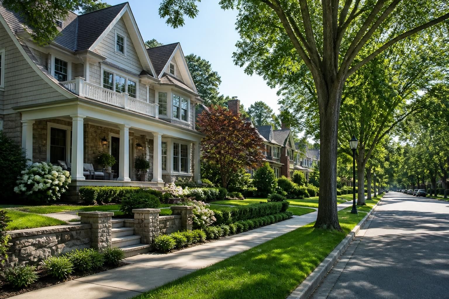 Elegant homes and manicured lawns on a calm neighborhood street.