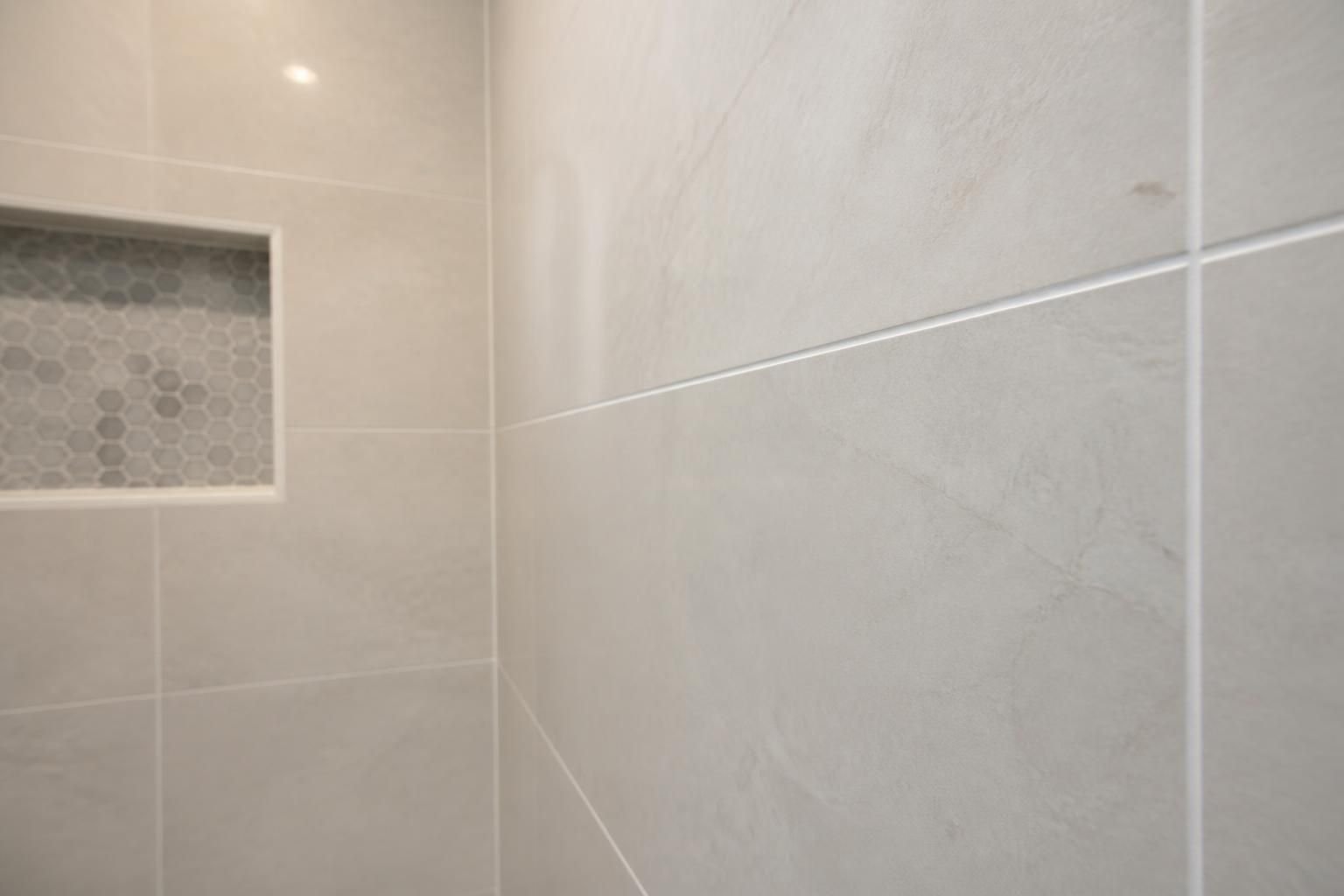 Freshly sealed grout lines in a finished shower area.